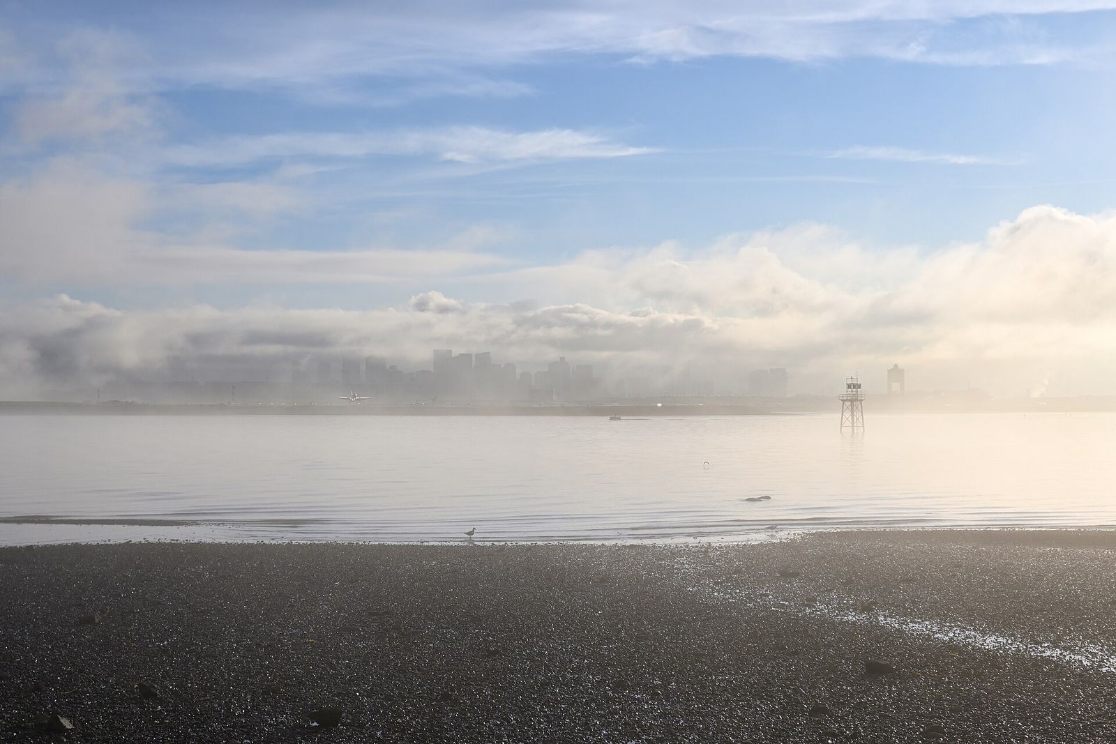 Boston skyline in morning fog over the harbor